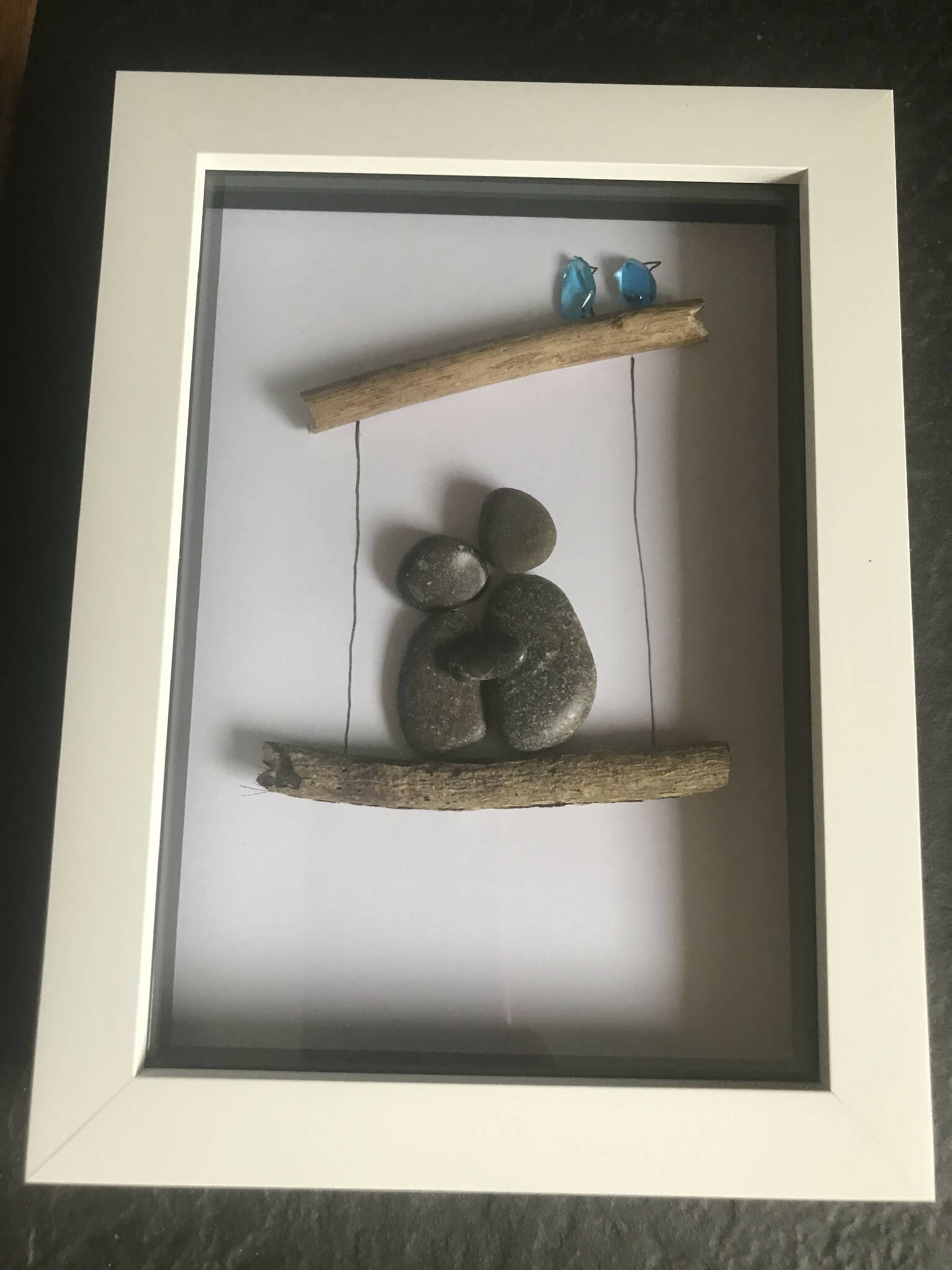 Couple on swing pebble art