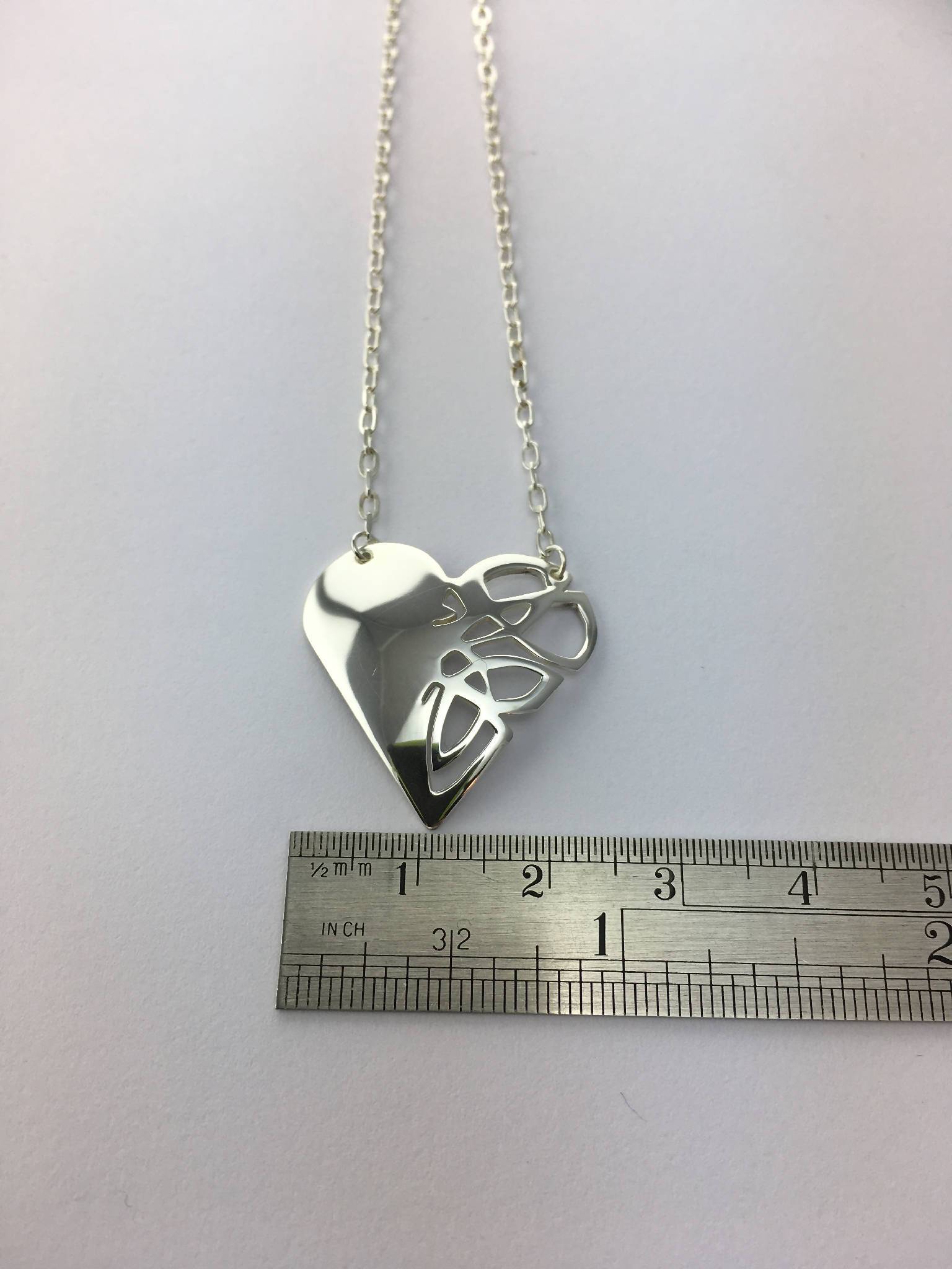 Heart shaped pendant, one side with a Celtic knot design
