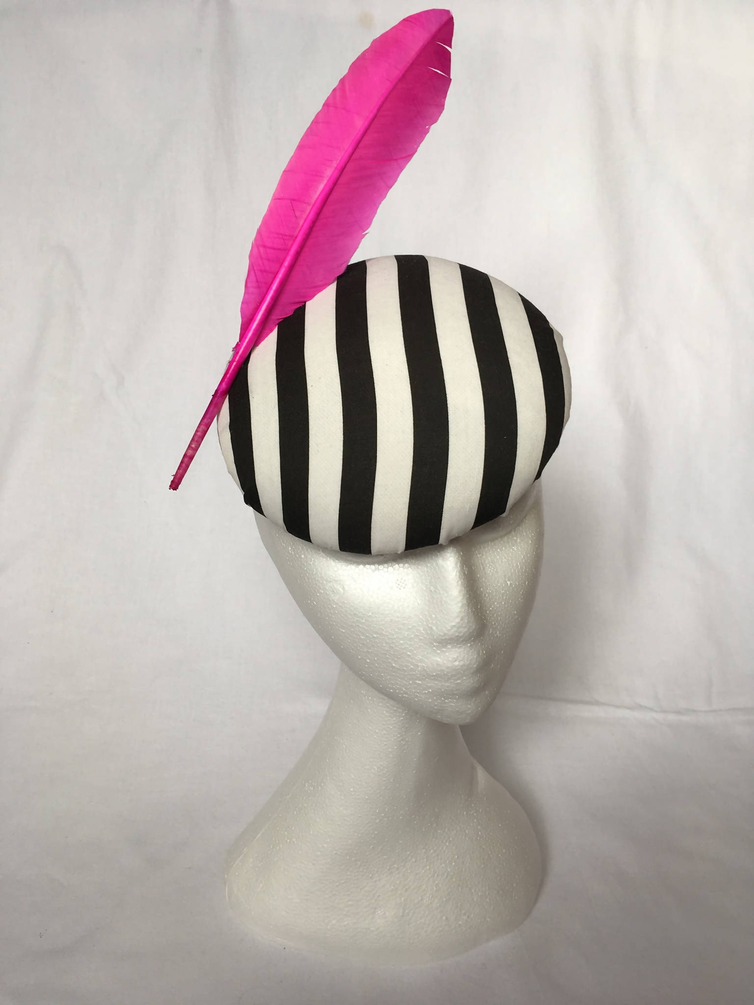 Black and white striped pillbox hat with pink feather detail (Pandora)