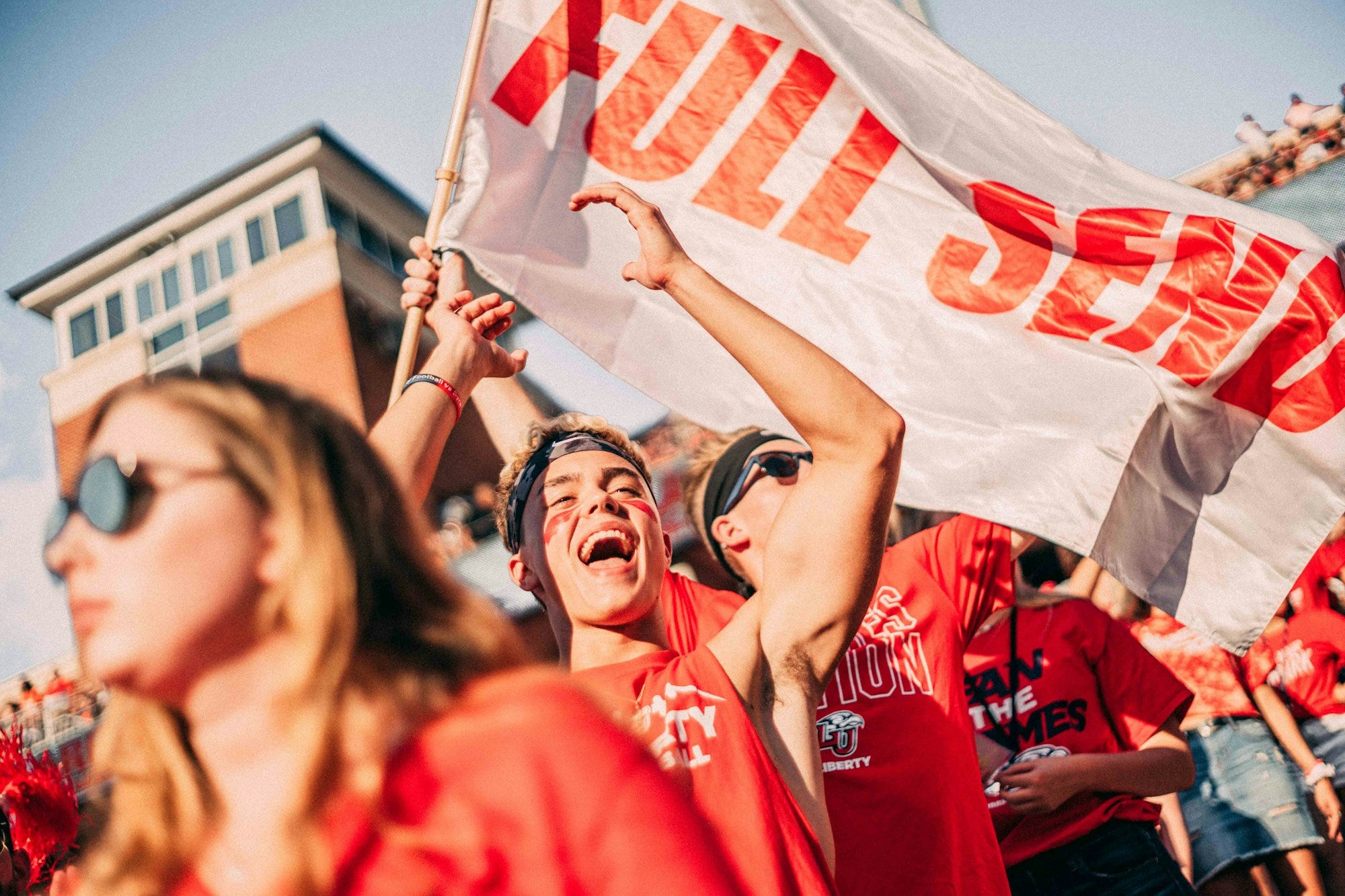 Welsh football supporters in red at a match, representing Y Wal Goch — The Red Wall