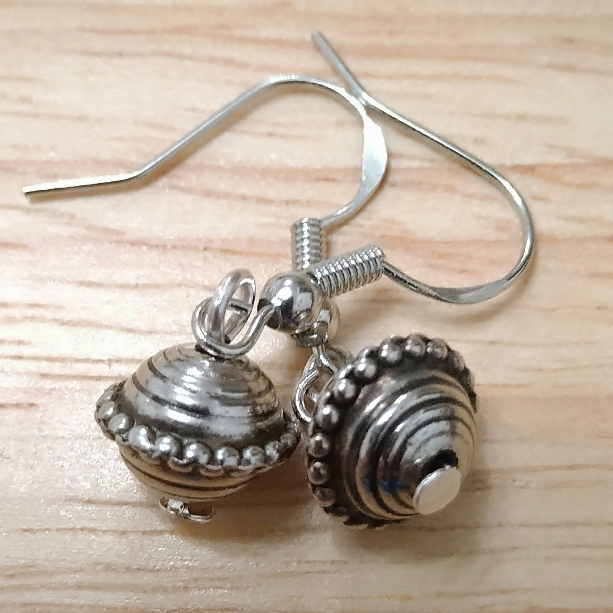 Handmade earrings with antique silver coloured bead