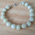 Cream coloured bracelet, handmade using recycled beads & silver coloured daisy spacers,17cm length