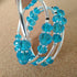 3 strand silver toned memory wire bangle with turquoise coloured beads, 6cm diameter