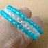 3 strand silver toned Memory wire child's bangle with blue & clear beads - 4cm diameter