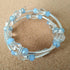 2.5 strand silver toned memory wire bangle with clear & pale blue beads, 6.5cm diameter