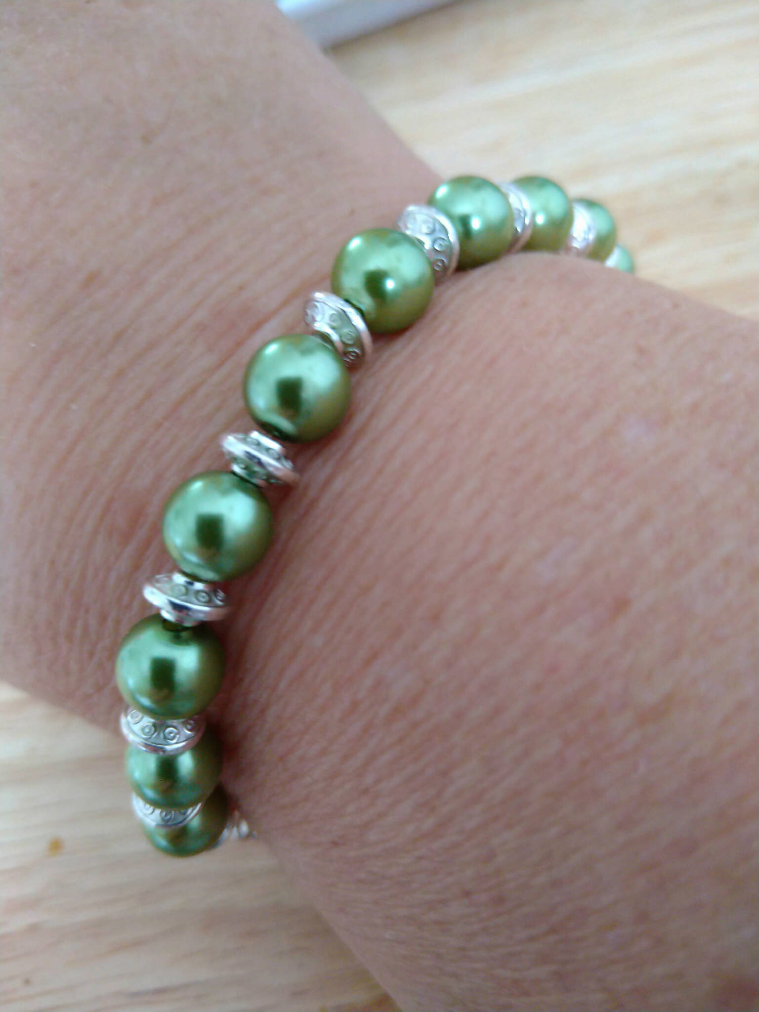 Green & Silver coloured bracelet, handmade using recycled green pearlescent beads & Silver coloured spacers. 21cm length
