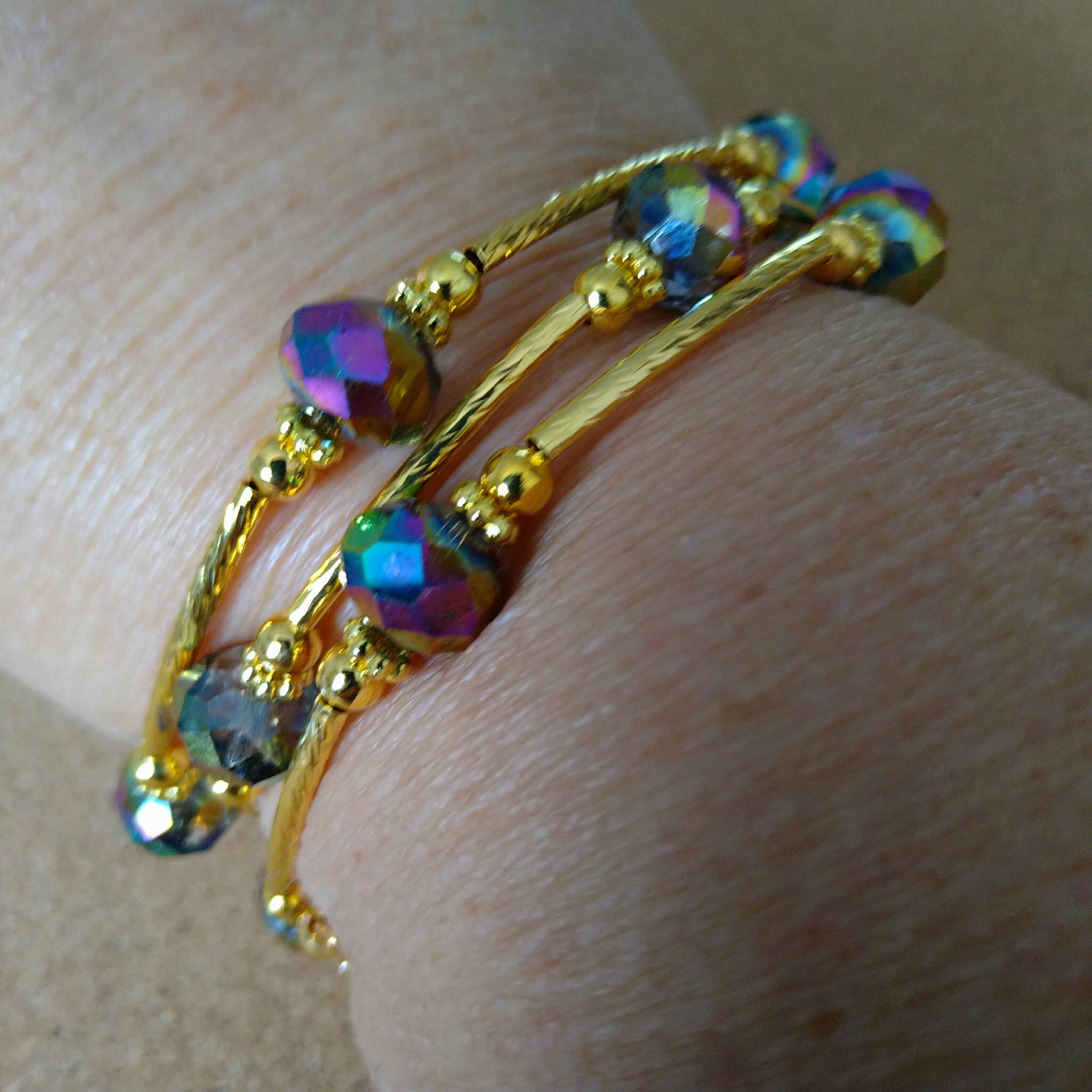 3 strand gold toned memory wire bangle with blue/purple AB finish beads, 6cm diameter