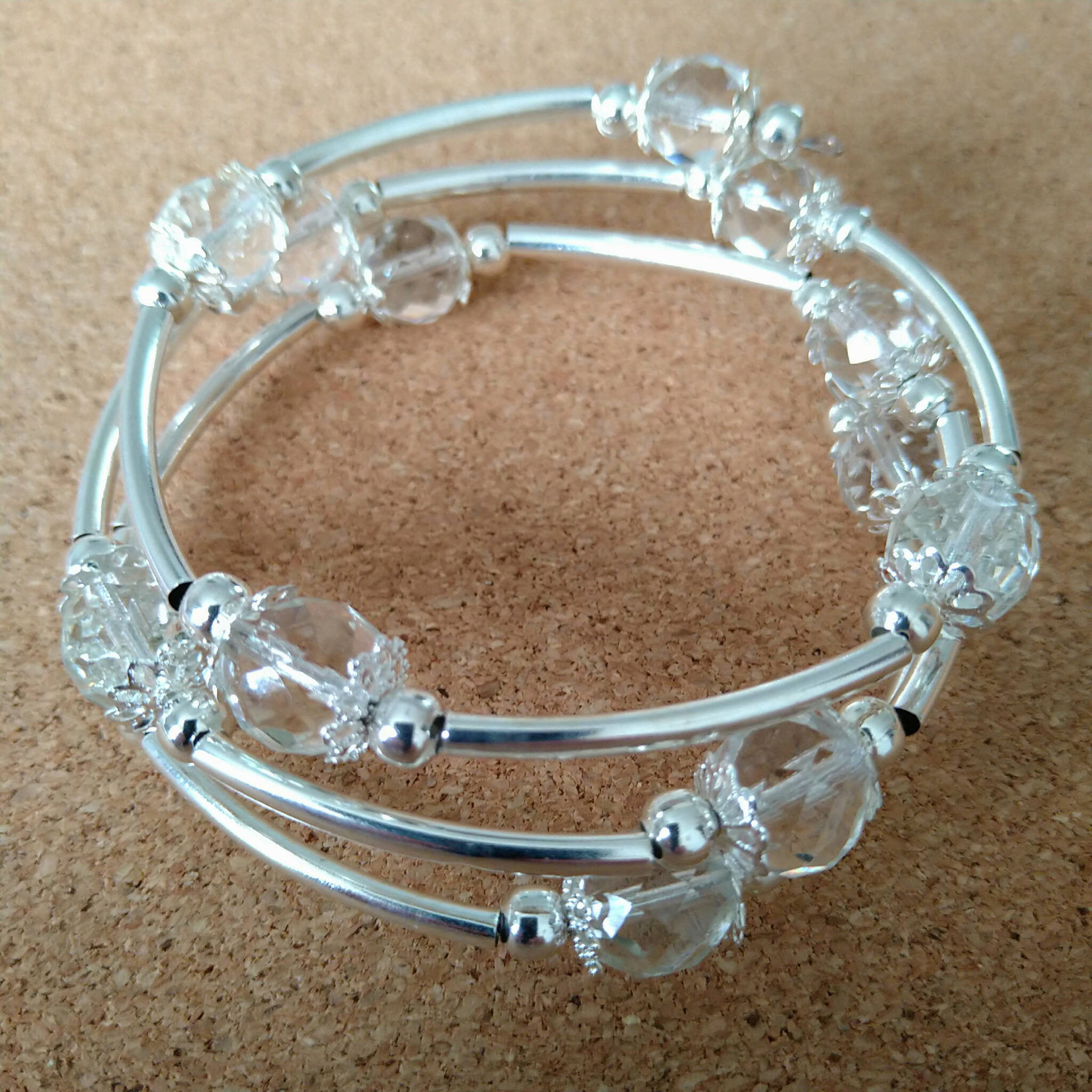 3 strand silver toned memory wire bangle with clear & silver coloured beads, 6.5cm diameter
