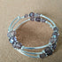 2.5 strand silver toned memory wire bangle with smoky grey beads, 6.5cm diameter
