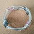 3 strand silver toned memory wire bangle with grey, pink & silver coloured beads, 6cm diameter