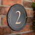 Round rustic slate house number