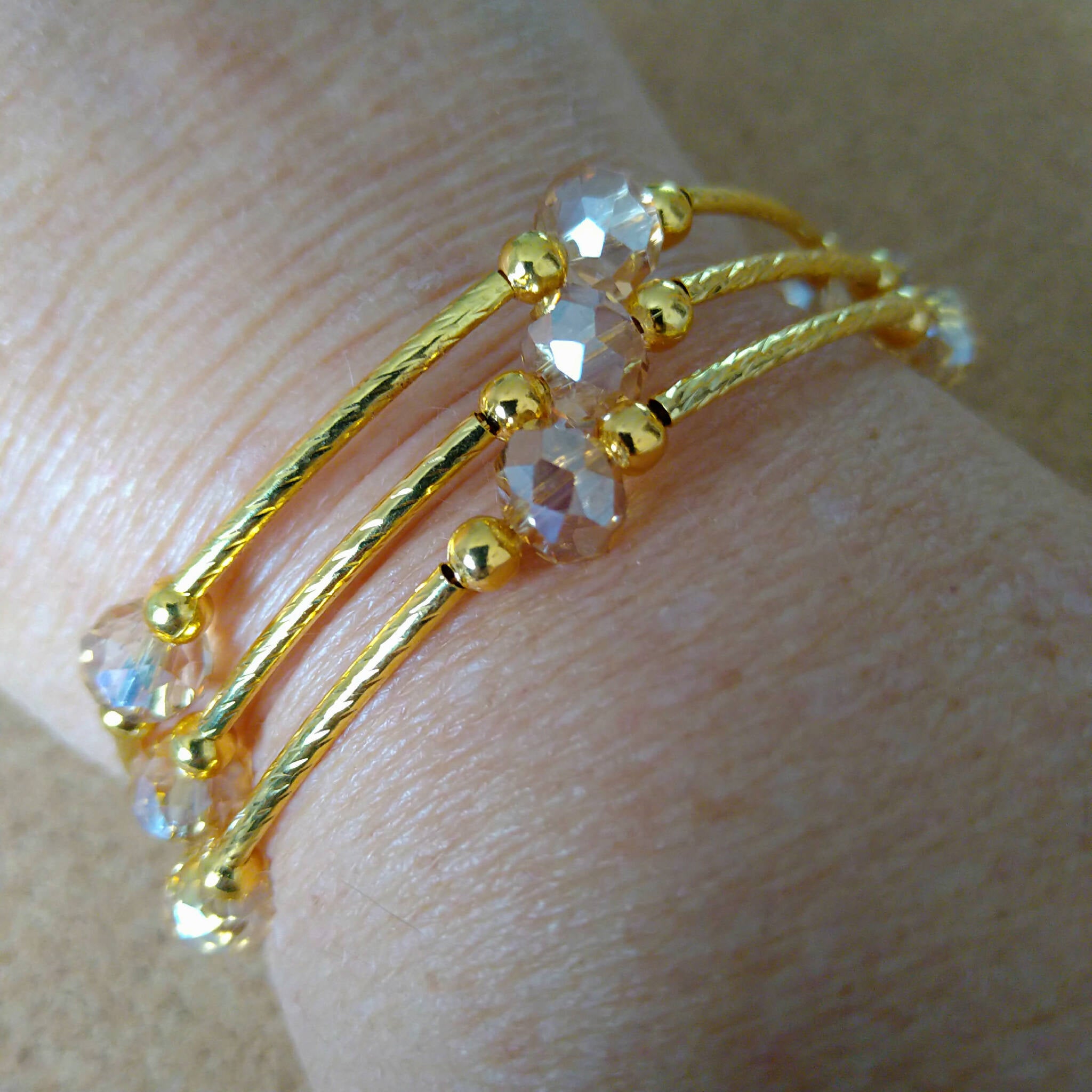3 strand gold toned memory wire bangle with champagne & gold beads, 6cm diameter