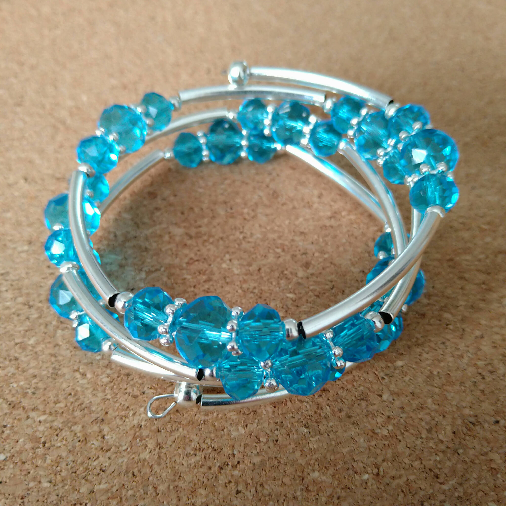 3 strand silver toned memory wire bangle with turquoise coloured beads, 6cm diameter