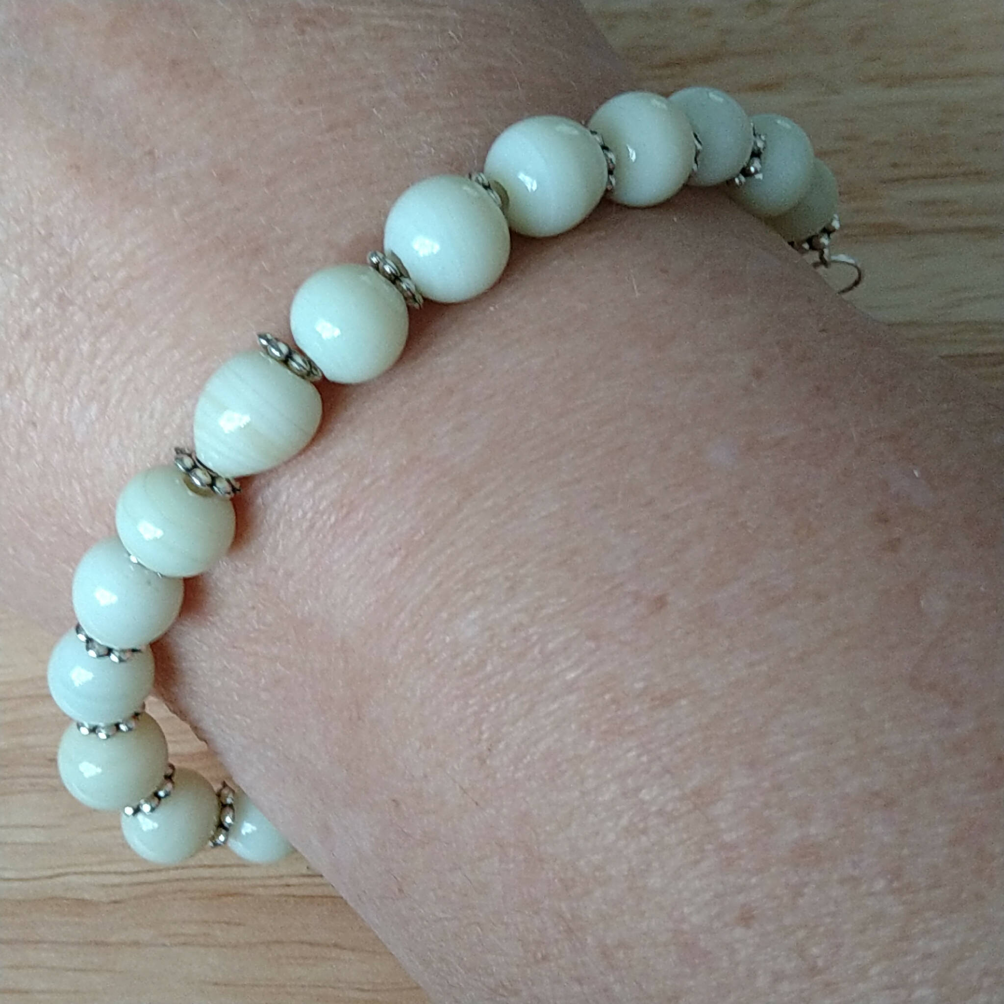 Cream coloured bracelet, handmade using recycled beads & silver coloured daisy spacers,17cm length