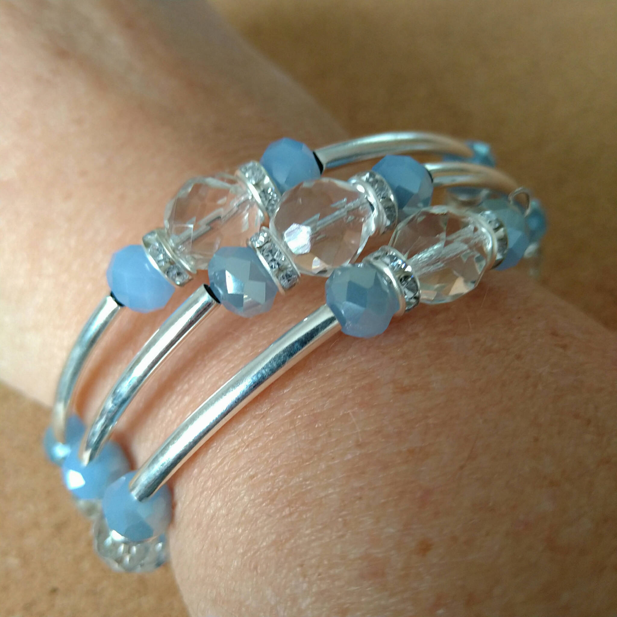 2.5 strand silver toned memory wire bangle with clear & pale blue beads, 6.5cm diameter