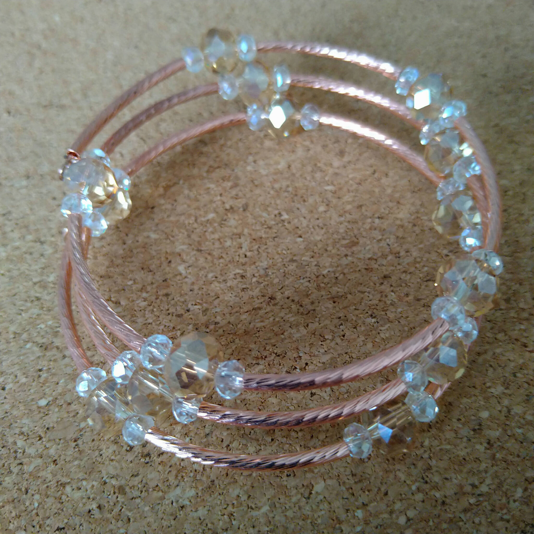 3 strand rose gold toned memory wire bangle with champagne & clear beads, 6cm diameter