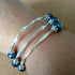 3 strand silver toned crimped memory wire bangle with blue & silver coloured beads, 6.5cm diameter