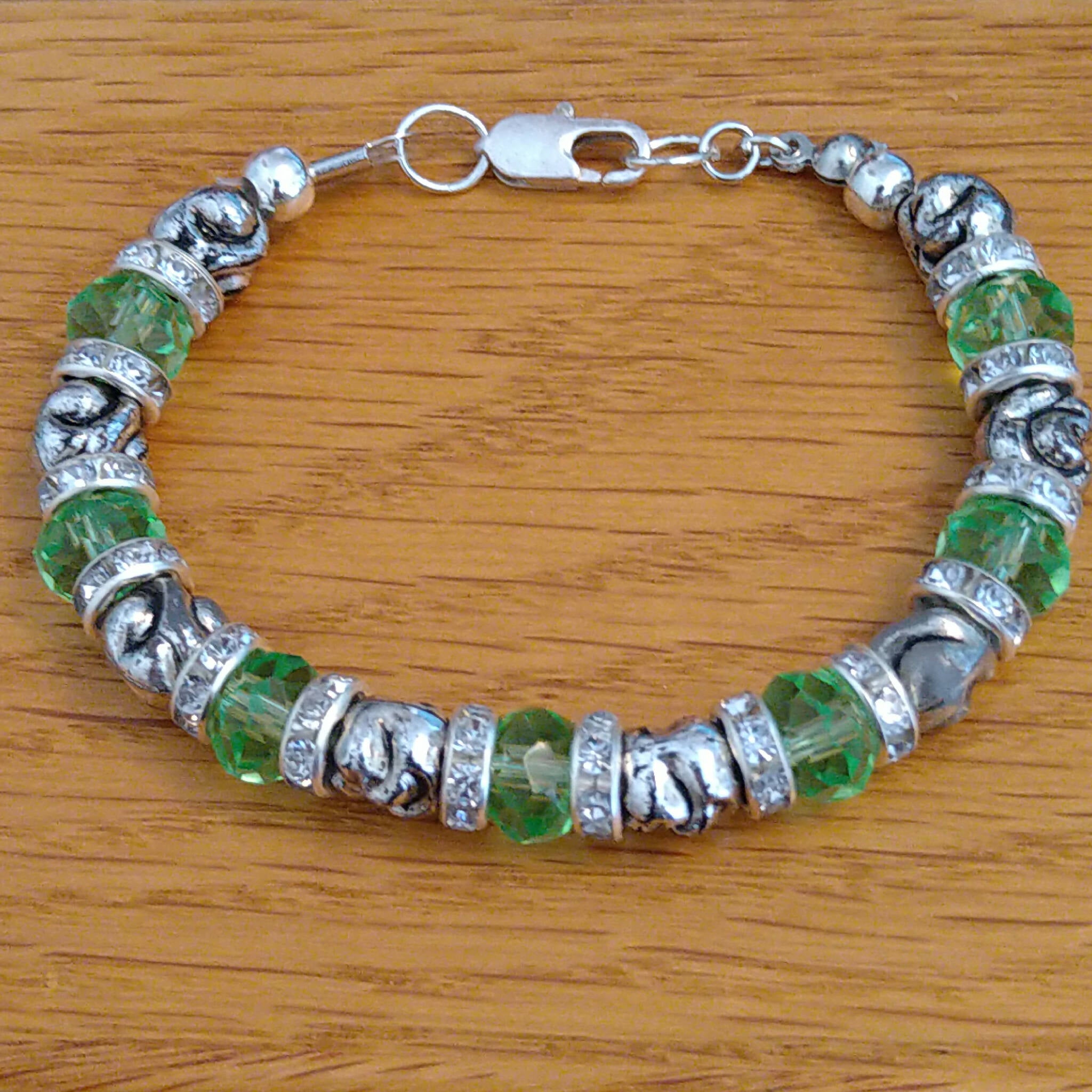 Handmade bracelet with recycled green & silver coloured beads & rhinestone rondelle spacers. Upcycled