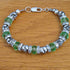 Handmade bracelet with recycled green & silver coloured beads & rhinestone rondelle spacers. Upcycled