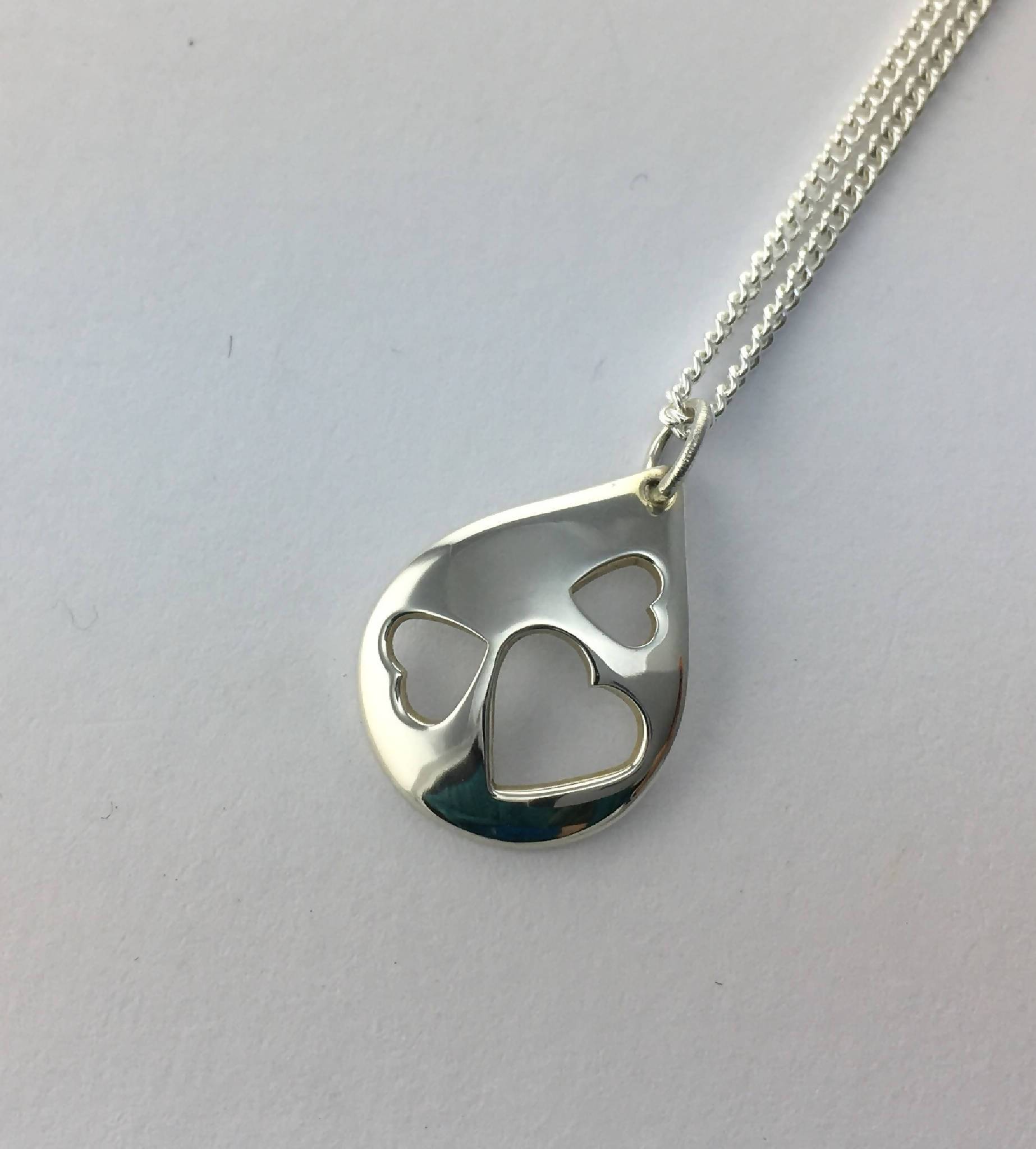 Small teardrop filled with three hearts pendant