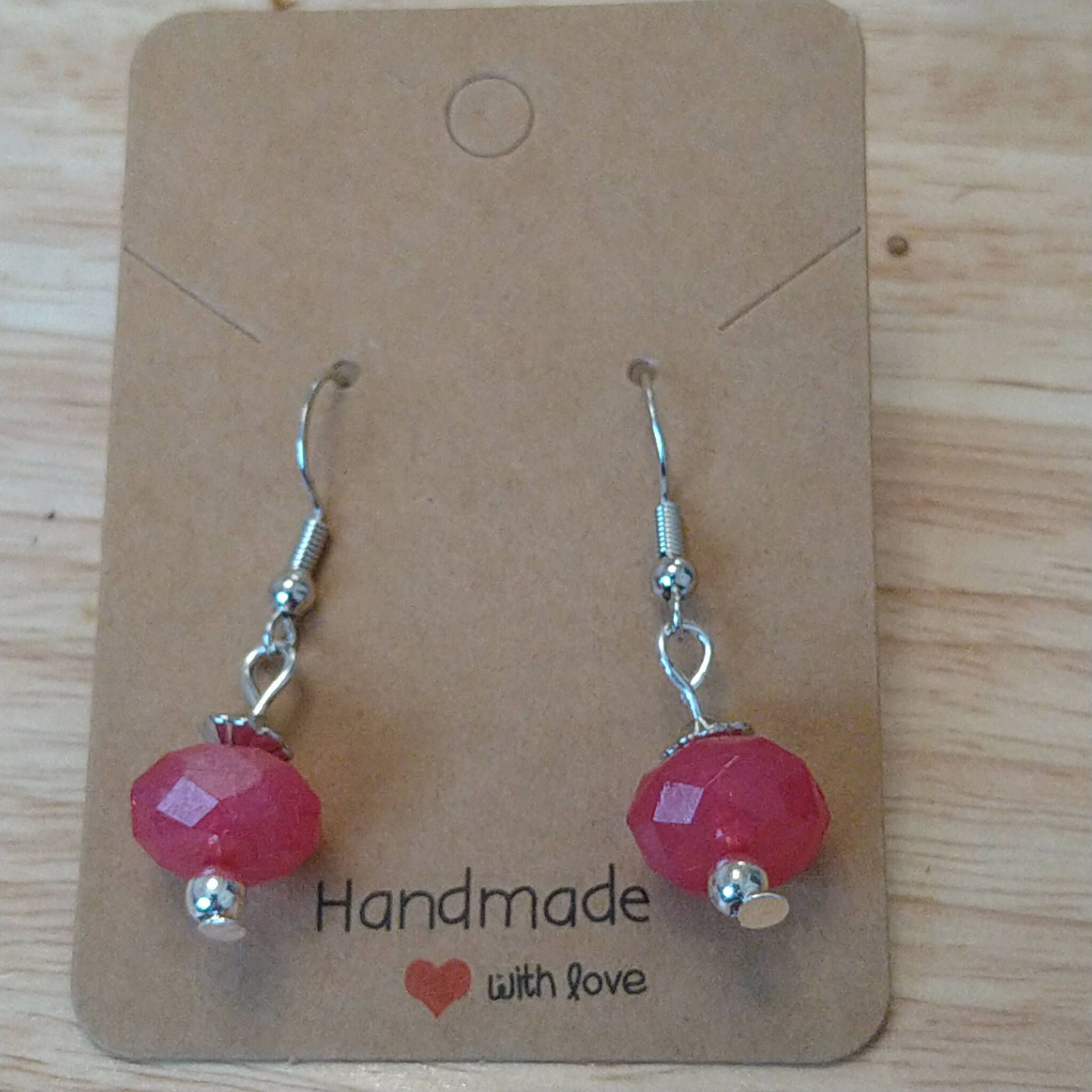 Handmade earrings with red faceted bead